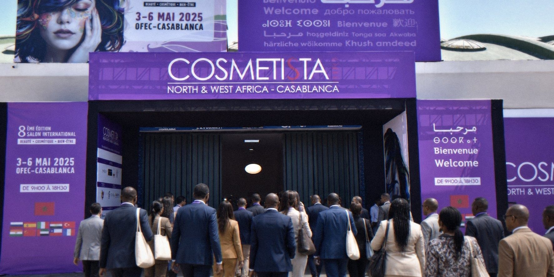 Visitors in business dress walking into the entrance of the Cosmetista Expo North & West Africa trade fair in Casablanca, under purple multilingual welcome banners